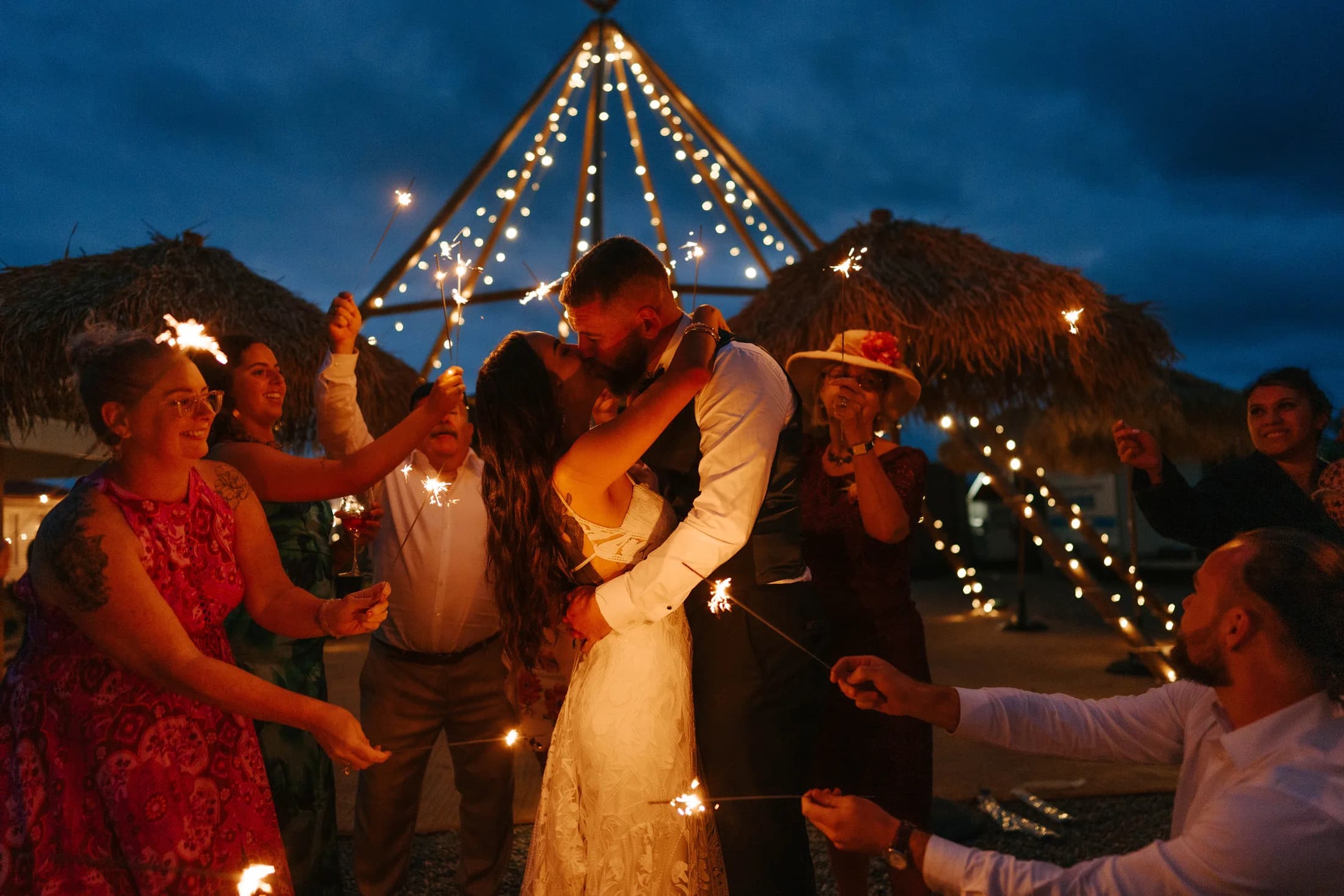 Couple beneath festoon lights at night