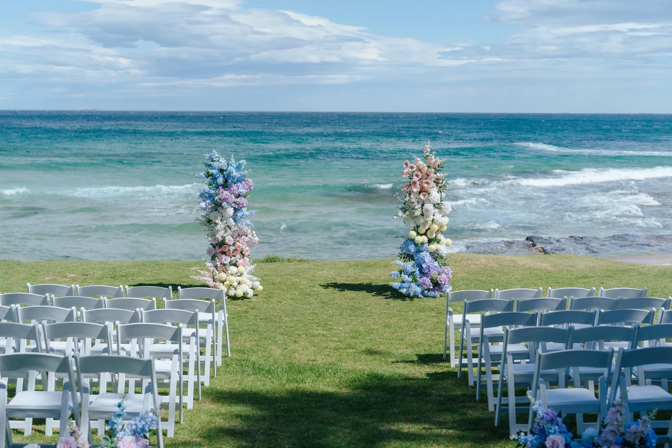 Beach ceremony with floral arbours