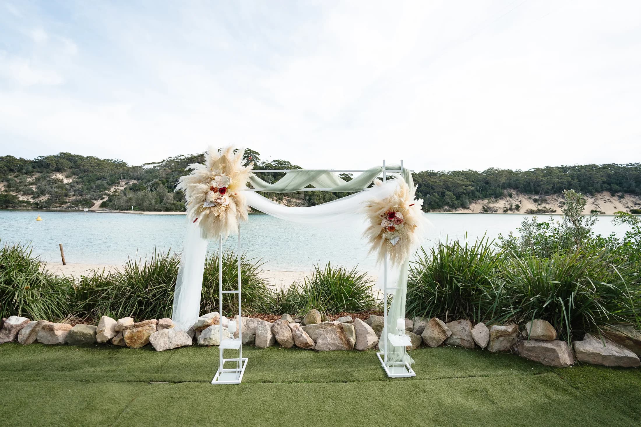 Beach ceremony with floral arbours